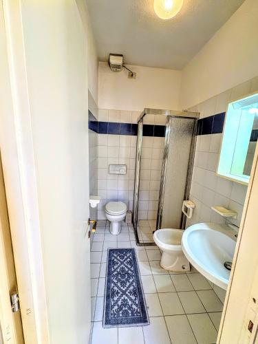 a bathroom with a toilet and a sink and a shower at Wild Paradise in Costa Paradiso