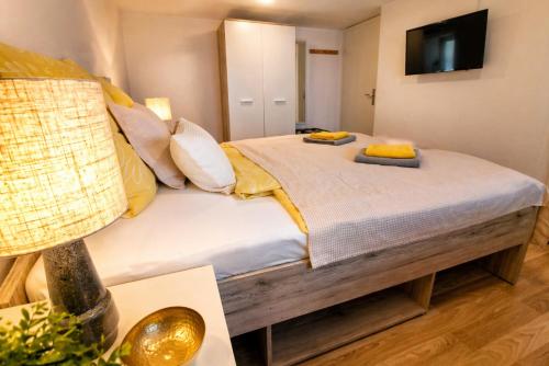 a bedroom with a bed with yellow pillows on it at Gemütliches Apartment am Bad Muskauer Park Sauna zu buchbar Hunde willkommen Ruhige Lage in Bad Muskau