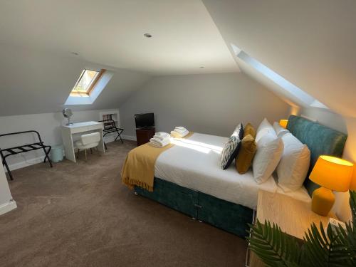 a bedroom with a large bed and a desk at Forth, Pittenweem in Pittenweem