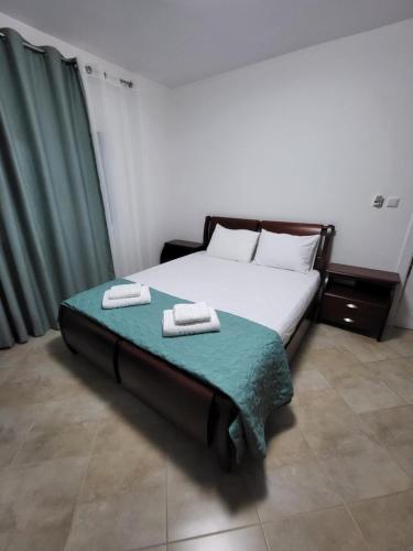 a bedroom with a bed with two towels on it at Krasaqua in Pogradec