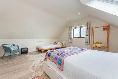 a bedroom with a large bed in a attic at Saoirse in East Wittering