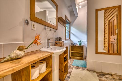 a bathroom with a sink and a mirror at TropicalArts Resort&Studios in Bocas Town