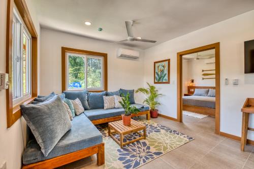 a living room with a blue couch and a table at TropicalArts Resort&Studios in Bocas Town
