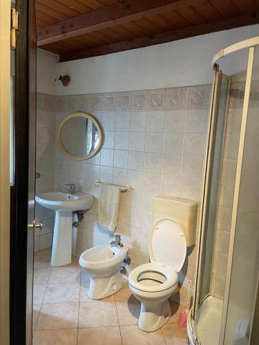 a bathroom with a toilet and a sink at Casa nonna Bruna in Montebruno