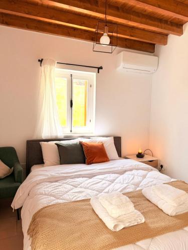 a bedroom with a large bed and a window at Estia Vouni Boutique Houses in Vouni