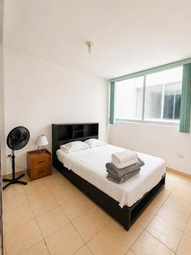 a bedroom with a bed and a large window at Departamento Harmony Xalapa in Xalapa
