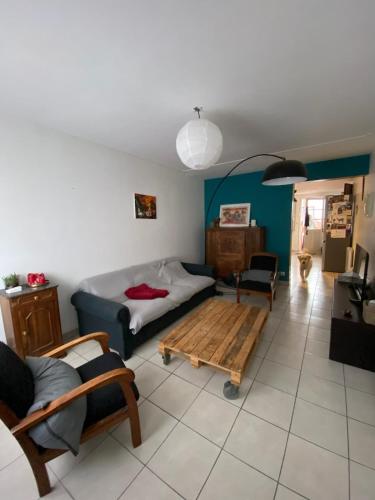 a living room with a couch and a coffee table at Maison de ville quartier saint-pierre in Brest