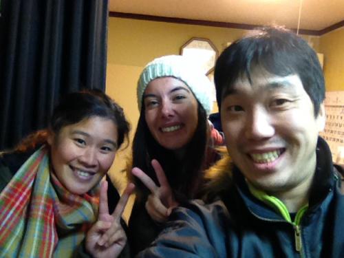a man and two women giving the peace sign at NOW TRAVEL ShinOsaka in Osaka