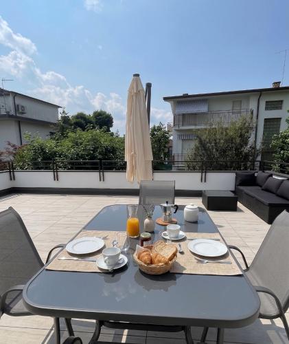a table with a bowl of food on a patio at LA TERRAZZA - Very Quiet - Free park - 3 min from Varese center and lake - AIR Conditioning - Cycling friendly in Varese