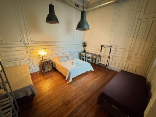 a bedroom with a bed and a wooden floor at Casamor in Buenos Aires