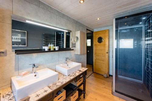 a bathroom with two sinks and a shower at Ainos Louanges - Bail Partner in Auxerre