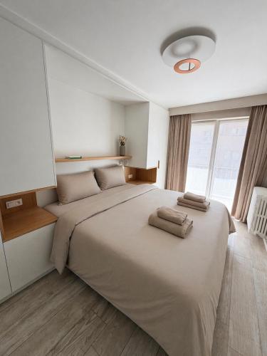 a bedroom with a large bed with two towels on it at Knokke Sea, Appartement Vue mer in Knokke-Heist