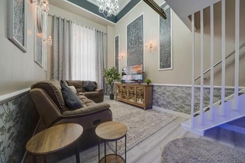 a living room with a couch and a table at Luxurious Royal 2BR Apartment, Glasgow City Centre in Glasgow