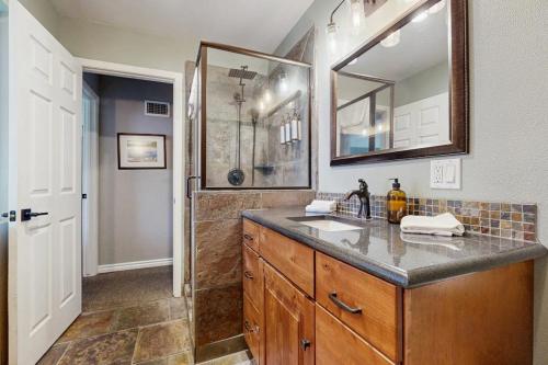 a bathroom with a sink and a shower at Bass Lake Lodge in Bass Lake