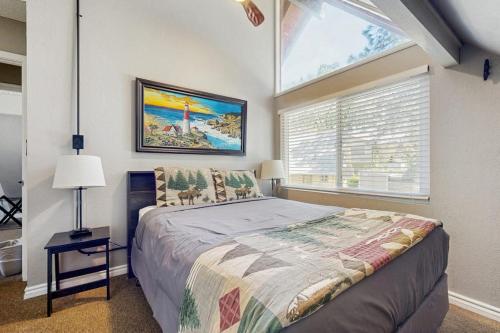 a bedroom with a large bed and a window at Bass Lake Lodge in Bass Lake