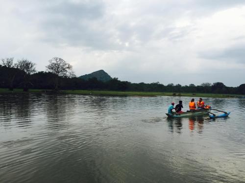 a group of people in a boat on a river at La Pentera in Hambegamuwa