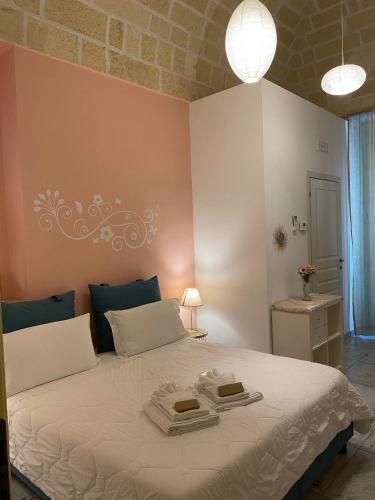 a bedroom with a bed with two towels on it at Antica Dimora Le sette Lune in Altamura