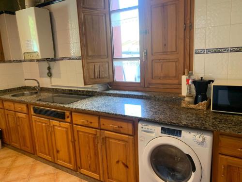 a kitchen with a washing machine and a sink at Escuelas de collía B AT-1537-AS in Arriondas