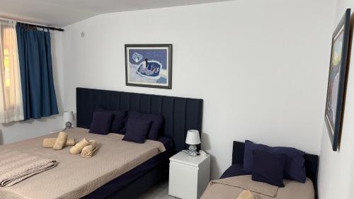 a bedroom with a bed with blue pillows at Villa art colony in Ohrid