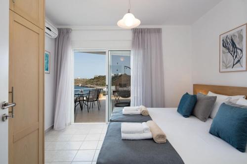a bedroom with a bed and a view of the ocean at Tersanas Seaside Apartment in Tersanas