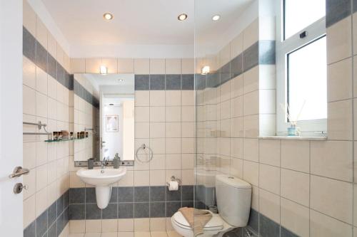 a bathroom with a toilet and a sink at Tersanas Seaside Apartment in Tersanas