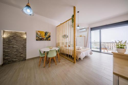 a room with a bed and a table and chairs at Apartamentos Sibarys in Nerja