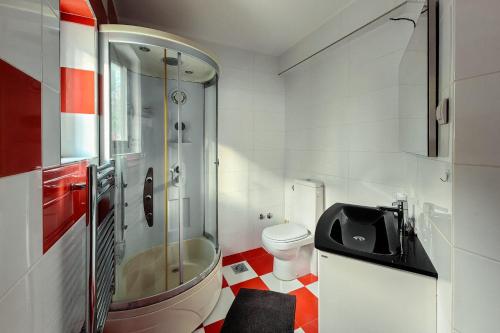 a bathroom with a shower and a toilet and a sink at Paradise Garden Villa in Bečići
