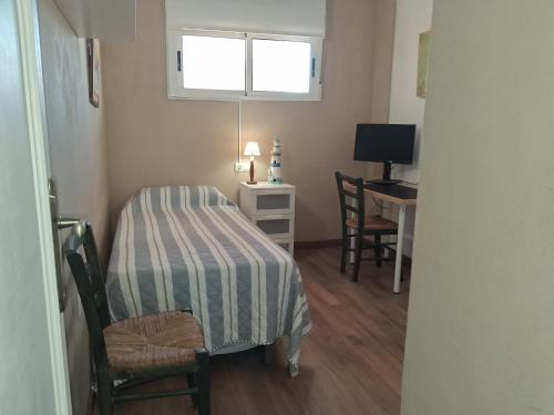 a room with a bed and a desk with a window at apartamento Cala Flores nº VV MU5868-1 in Cabo de Palos