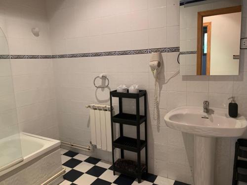a bathroom with a sink and a toilet and a phone at Escuelas de collía C AT-1537-AS in Arriondas