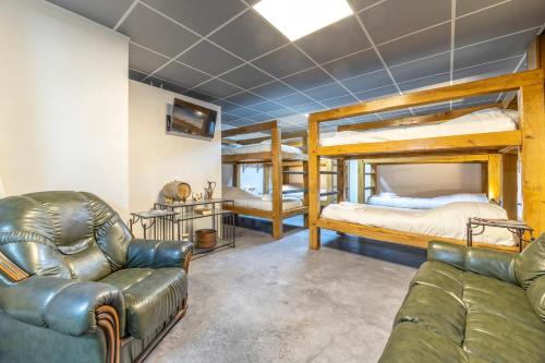 a living room with two bunk beds and a couch at Le Xilotik Gîte in Espelette