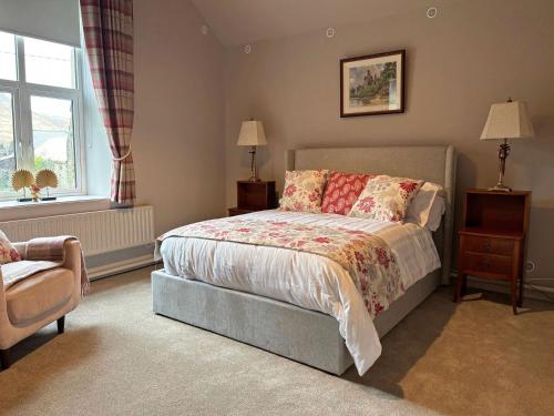 a bedroom with a bed and a chair and a window at Property 472 - Kylemore in Kylemore