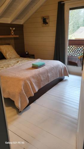 a bedroom with a bed and a window at Dans un parc privatif arboré in Réau