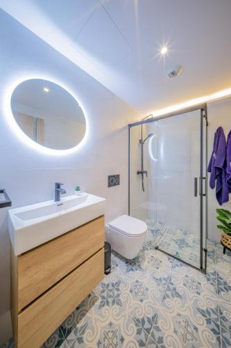 a bathroom with a sink and a shower and a toilet at Apartamentos Sibarys in Nerja