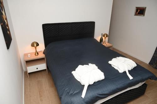 a bedroom with a bed with two white towels on it at Elysium2 in Banja Luka