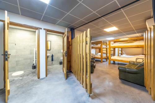a room with two bunk beds and a bathroom at Le Xilotik Gîte in Espelette