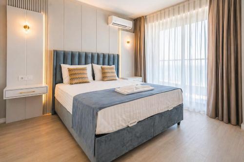 a bedroom with a large bed and a large window at Crystal by Solid Sea View Mamaia - Apartament langa plaja cu vedere la mare in Mamaia