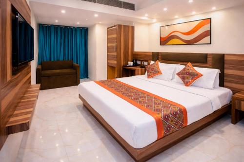 a hotel room with a bed and a chair at Hotel Golden Oasis - 5 Minute Walk from New Delhi Railway Station in New Delhi