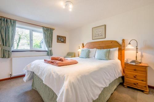 a bedroom with a large bed and a window at 1 Bed in Padstow oc-p00554 in Saint Merryn