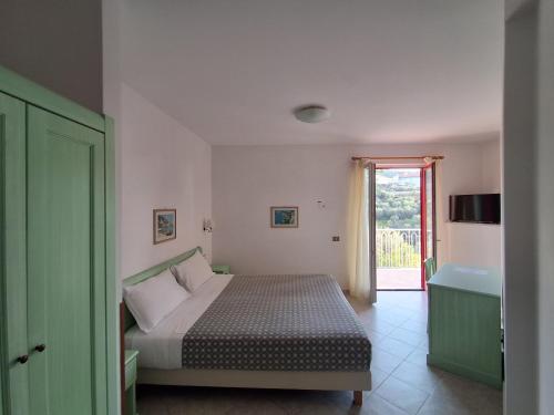 a bedroom with a bed and a bathroom with a door at Hotel Dania in Sorrento