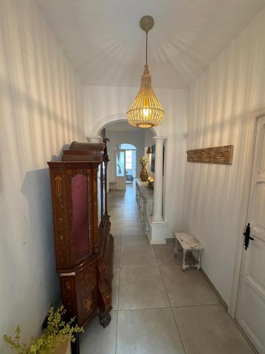 a hallway of a house with a chandelier at Céntrico duplex con piscina in Jávea