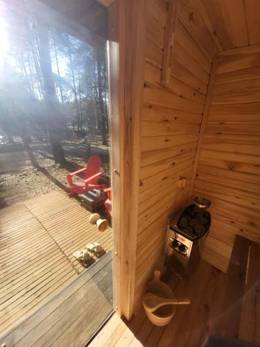 an inside view of a wooden sauna with a window at Nobelowka Forest SPA in Huta Podgórna