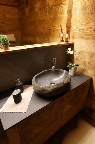 a bathroom with a stone sink on a counter at Maison Rita e Cello in La Salle