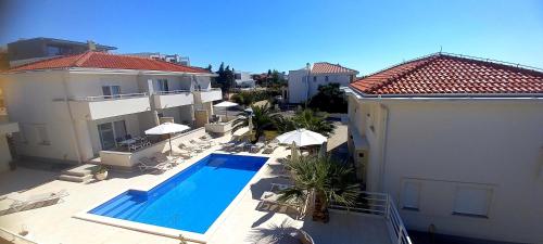 an aerial view of a building with a swimming pool at Luxury apartments Cuba in Novalja