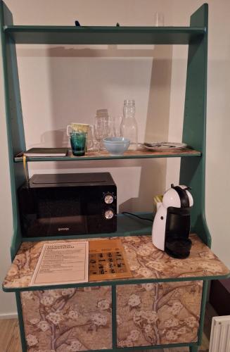 a display case with a microwave on a table at Saunamökki in Helsinki