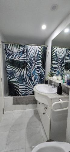 a bathroom with a sink and a zebra shower curtain at Three Horizons Penthouse El Saler in Valencia