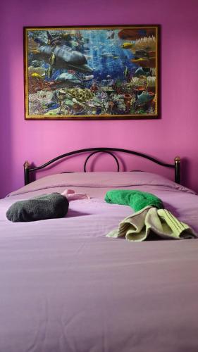 a bedroom with a bed with a painting on the wall at Mermaid house in Drama