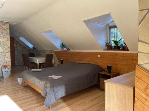 a bedroom with a bed in a attic at Gesztenyés Apartman Mátra Wellness in Parád
