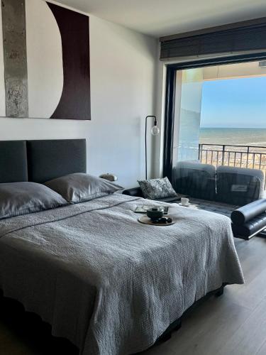 a bedroom with a bed with a view of the ocean at Baltic Infinity Suite 314 - SPA & Pool Access in Międzyzdroje