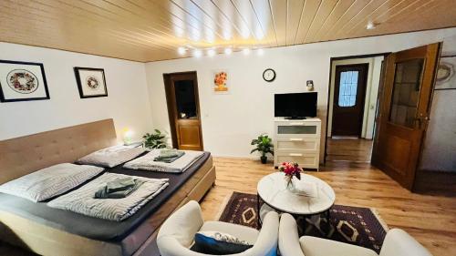 a bedroom with a bed and a table and a tv at Private Studio Apartment with Balcony in Dortmund-Brackel in Dortmund