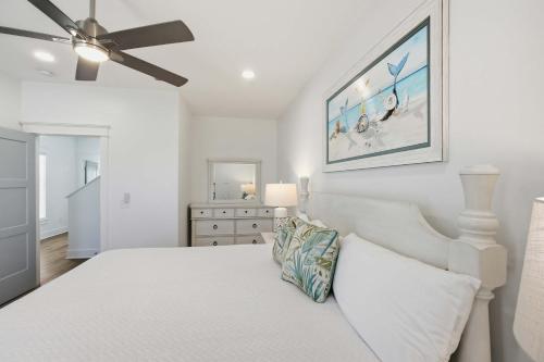 a white bedroom with a bed and a ceiling fan at Perfect location Pool 4 bedroom SGI Pet in Eastpoint